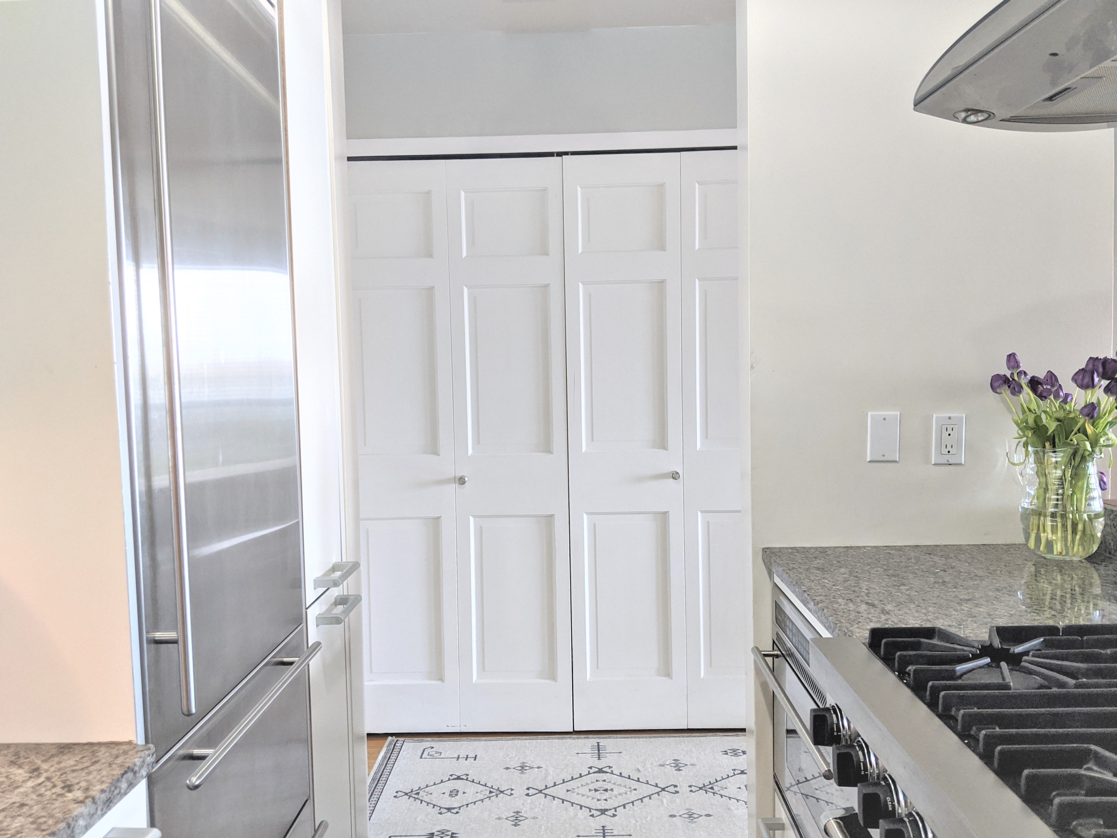 167 Perry Street, Unit 5N Manhattan, NY 10014 - Photo 6 of 12 a kitchen with granite countertop a refrigerator and a stove
