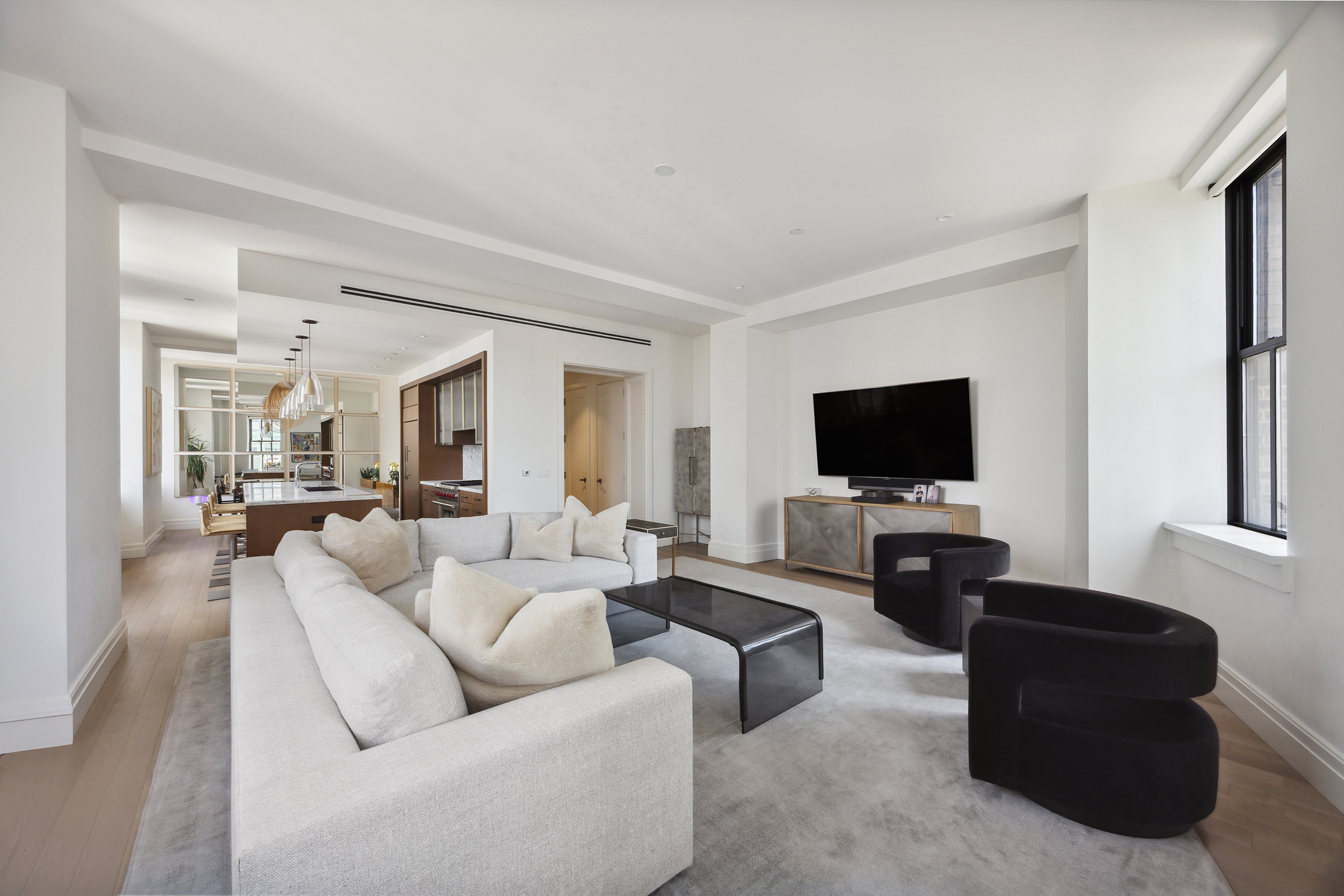 100 Barclay Street, Unit 15B Manhattan, NY 10007 - Photo 5 of 16 a living room with furniture and a flat screen tv