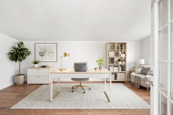 a living room with furniture a table and a potted plant