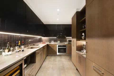 a kitchen with stainless steel appliances granite countertop a sink a stove and a refrigerator