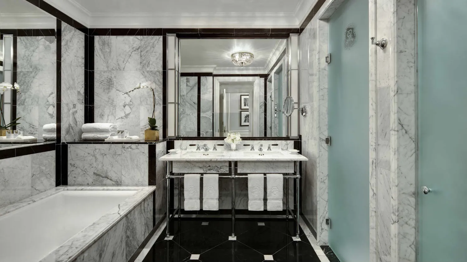 a bathroom with a granite countertop sink a large mirror and a bathtub