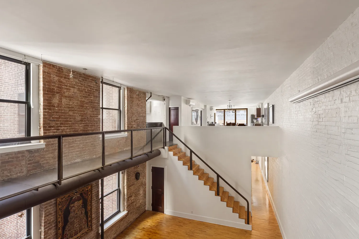 a view of staircase with lots of white walls and a window
