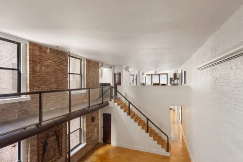 a view of staircase with lots of white walls and a window