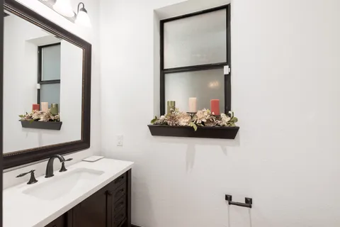 a view of a chair and table in backyard of the house