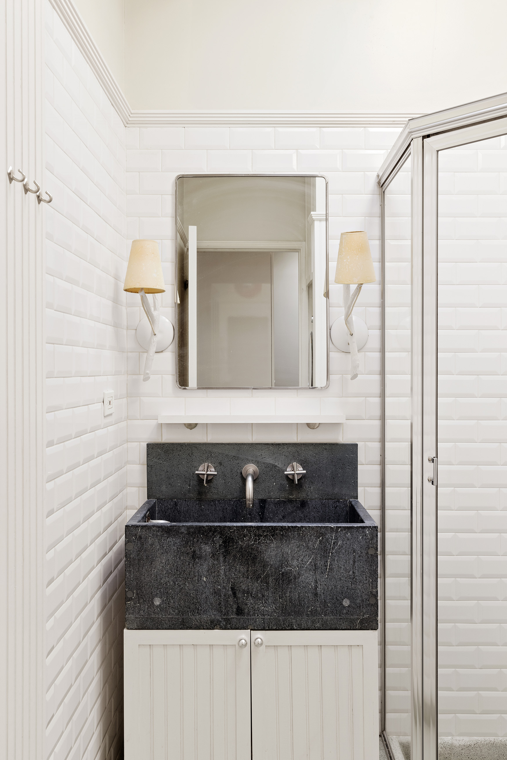 25 Perry Street Manhattan, NY 10014 - Photo 26 of 32 a bathroom with a sink and a mirror