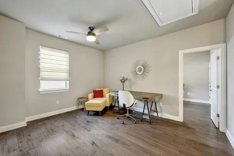 a view of a room with lounge chair and windows