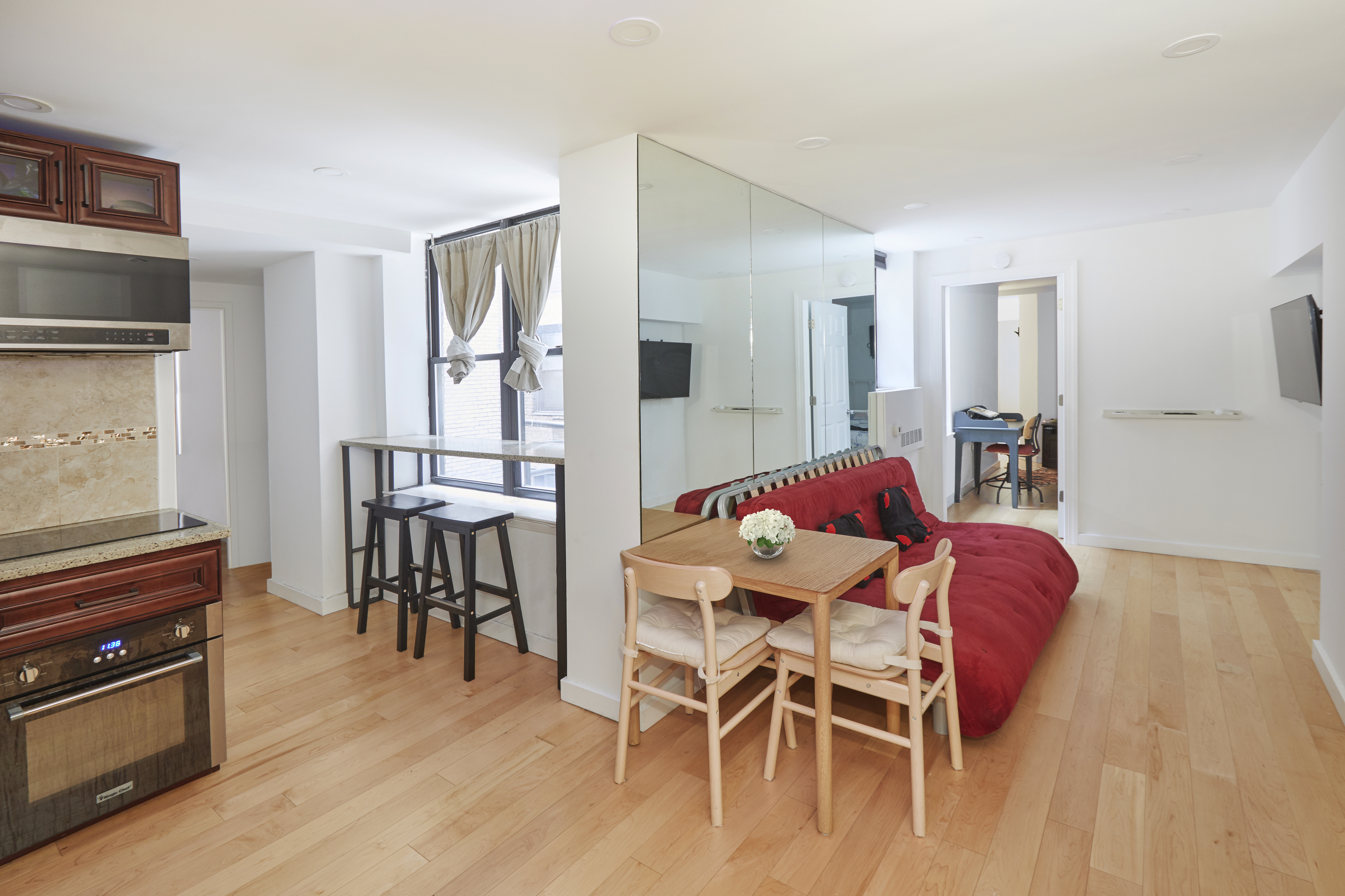 150 West 51st Street, Unit 1528 Manhattan, NY 10019 - Photo 19 of 21 a dining room with furniture and wooden floor
