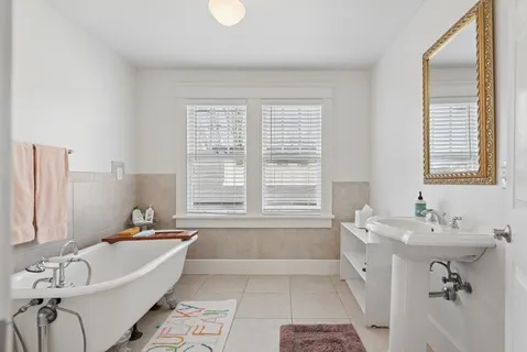 a bedroom with a bed potted plant and a window