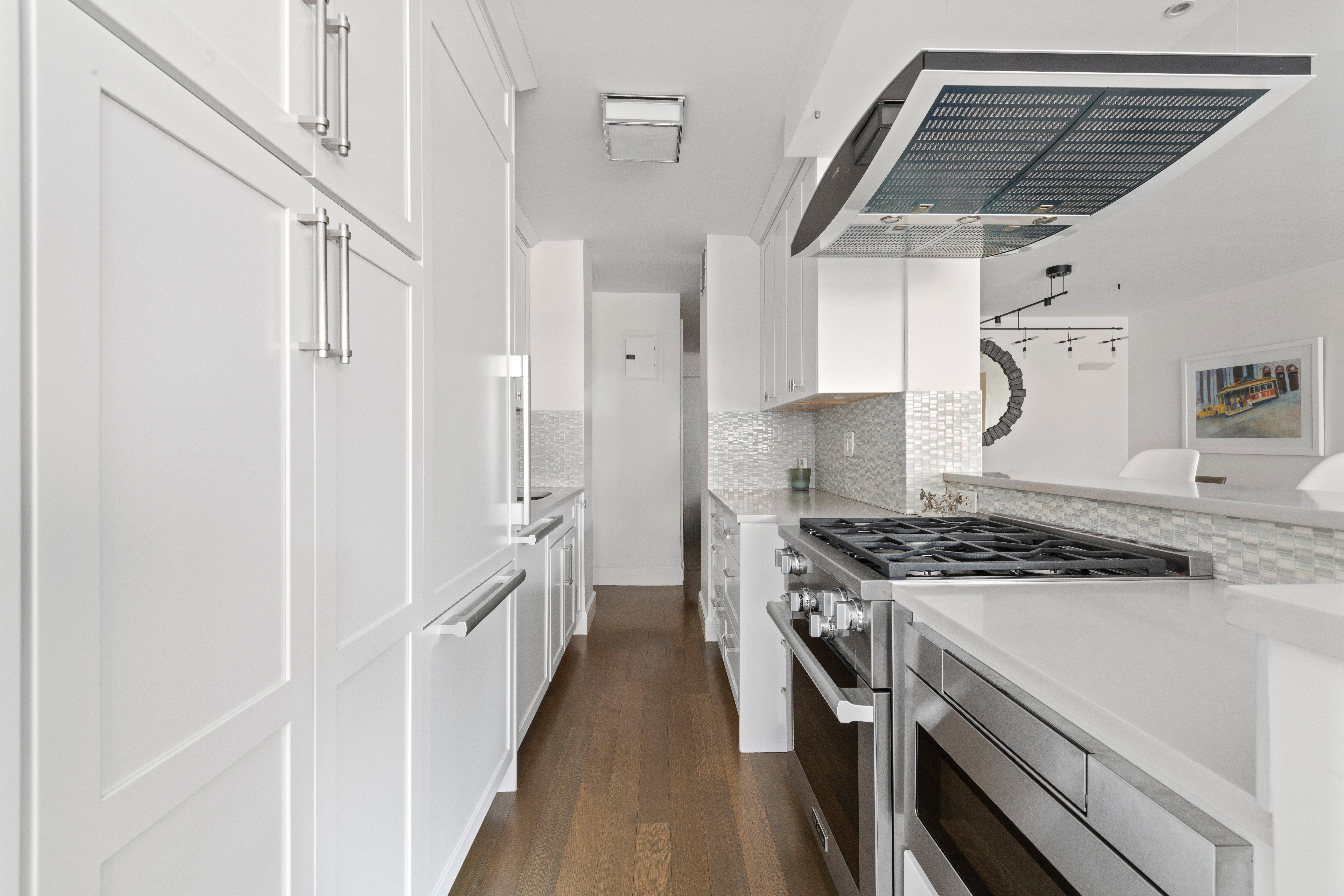 363 East 76th Street, Unit 7C Manhattan, NY 10021 - Photo 5 of 19 a kitchen with stainless steel appliances granite countertop a stove and a refrigerator