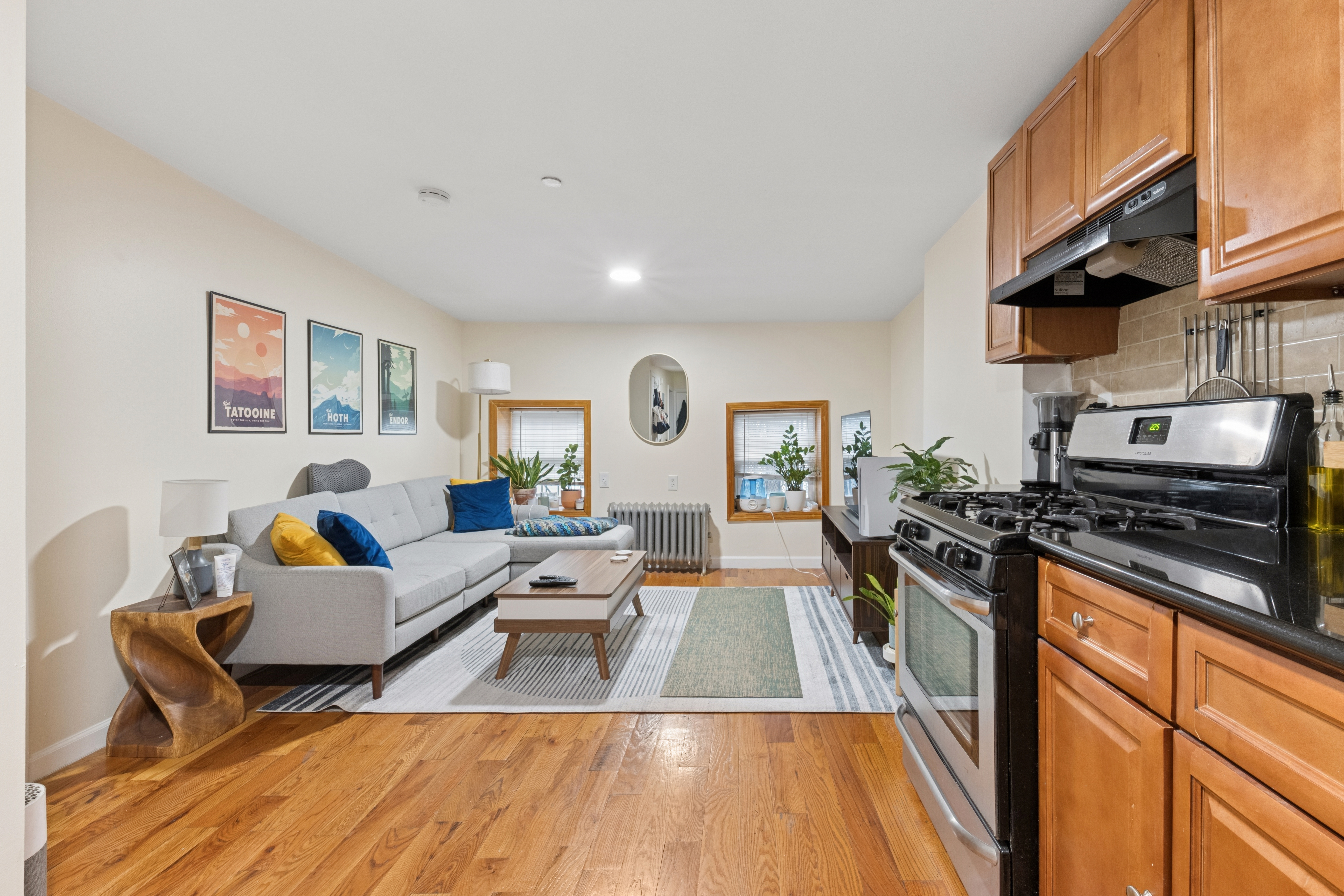 a living room with furniture and a wooden floor