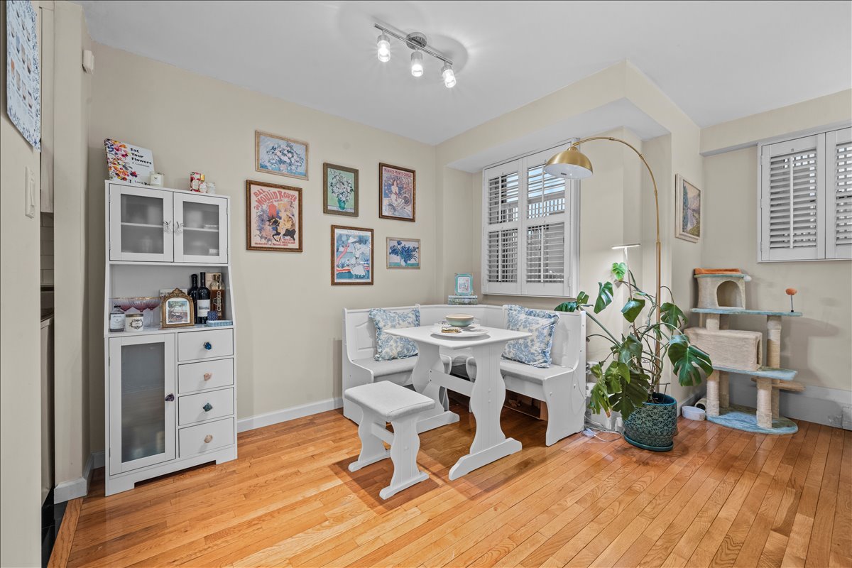 1175 York Avenue, Unit 1K Manhattan, NY 10065 - Photo 5 of 10 a workspace with furniture window and wooden floor