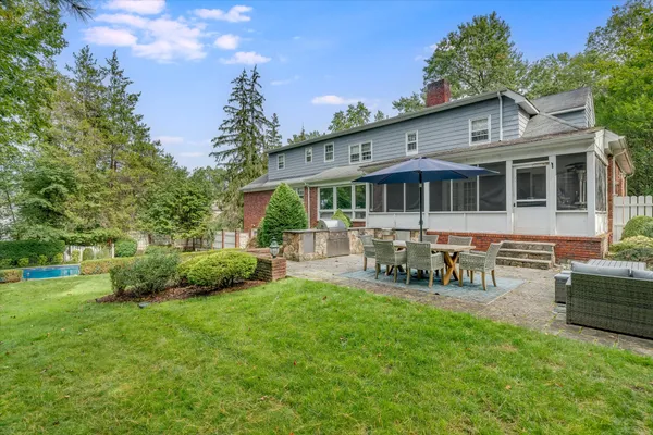 a view of a house with a yard porch and sitting area