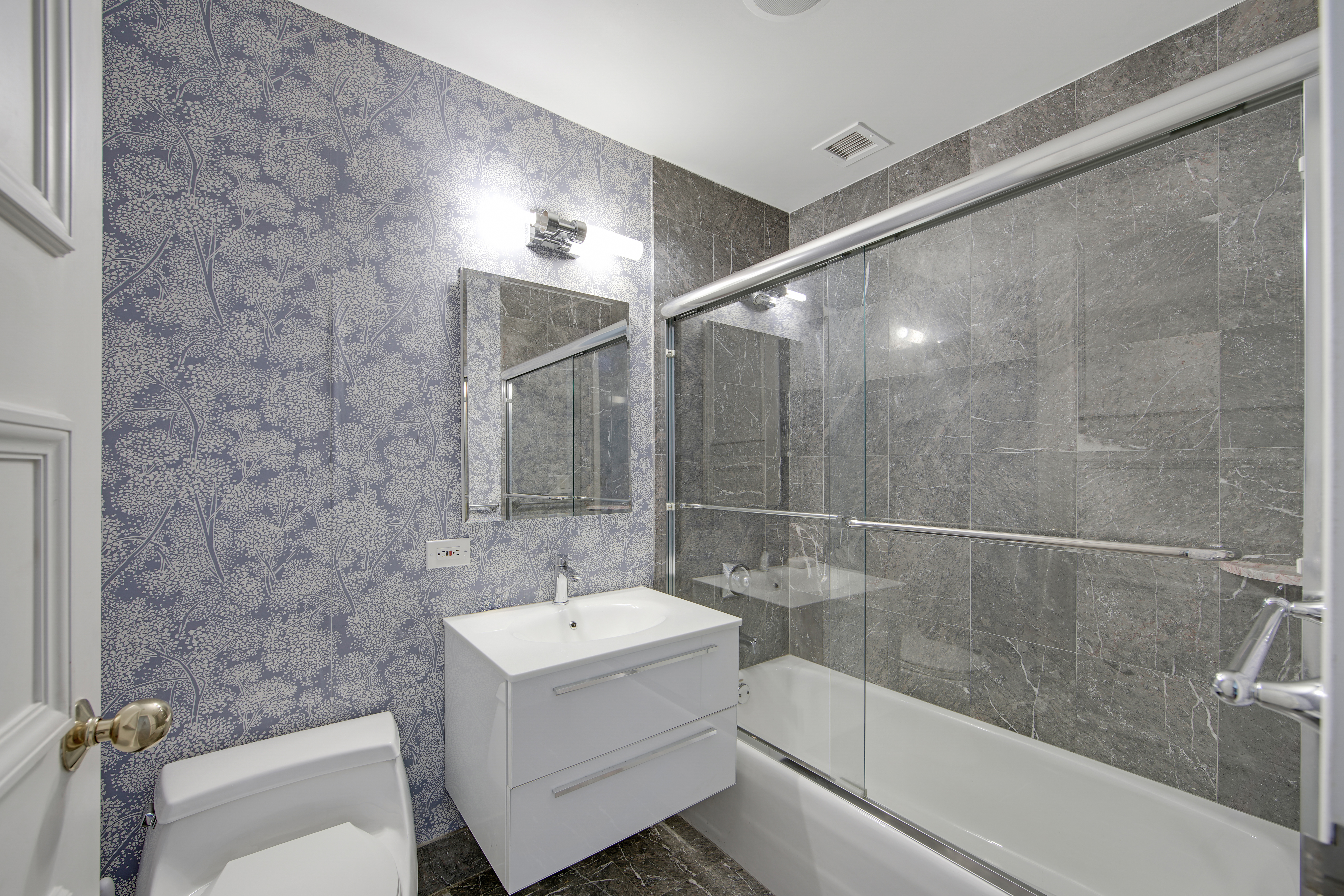 201 East 80th Street, Unit 16D Manhattan, NY 10075 - Photo 9 of 19 a bathroom with a sink a toilet and shower