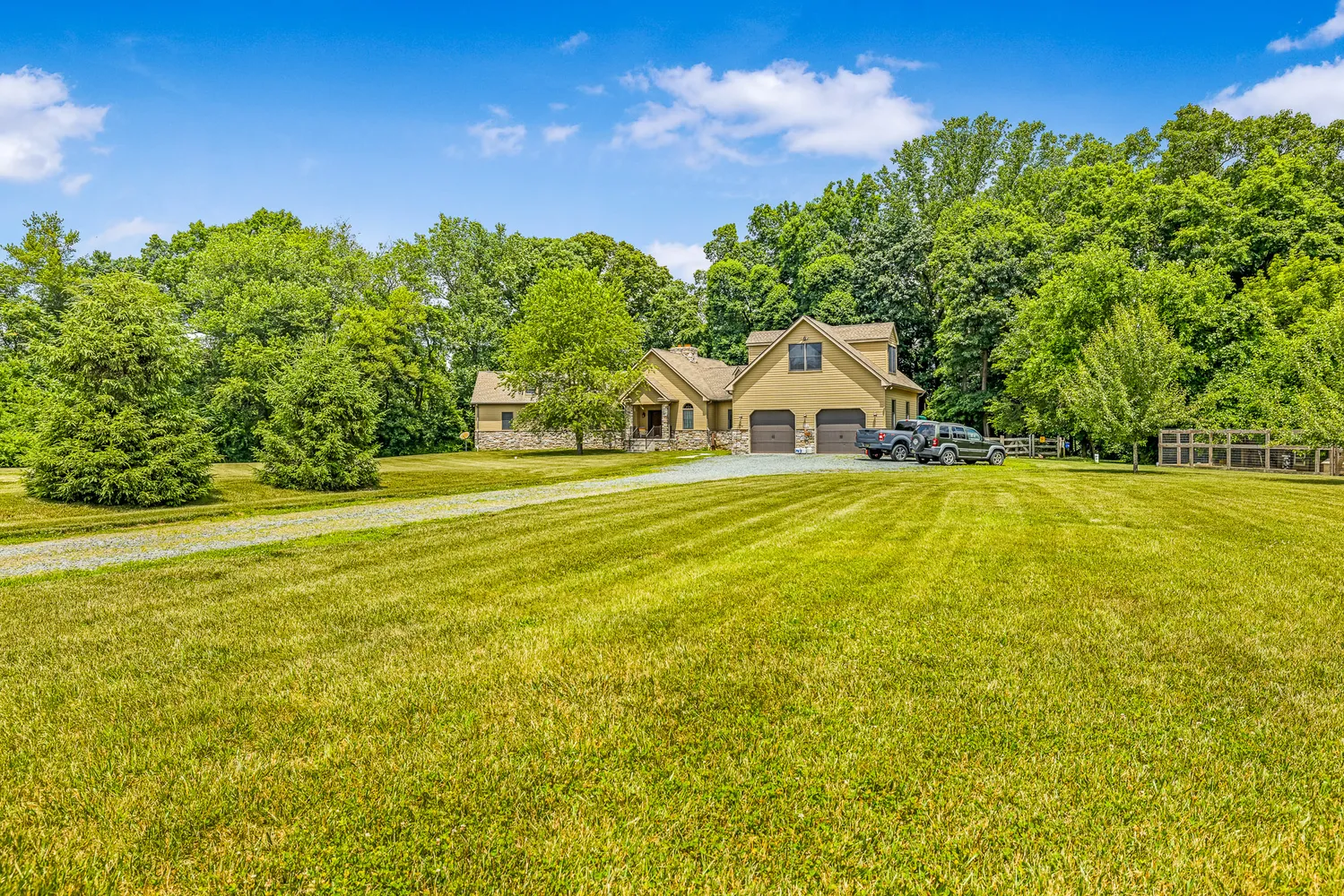 a house view with swimming pool in front of the house