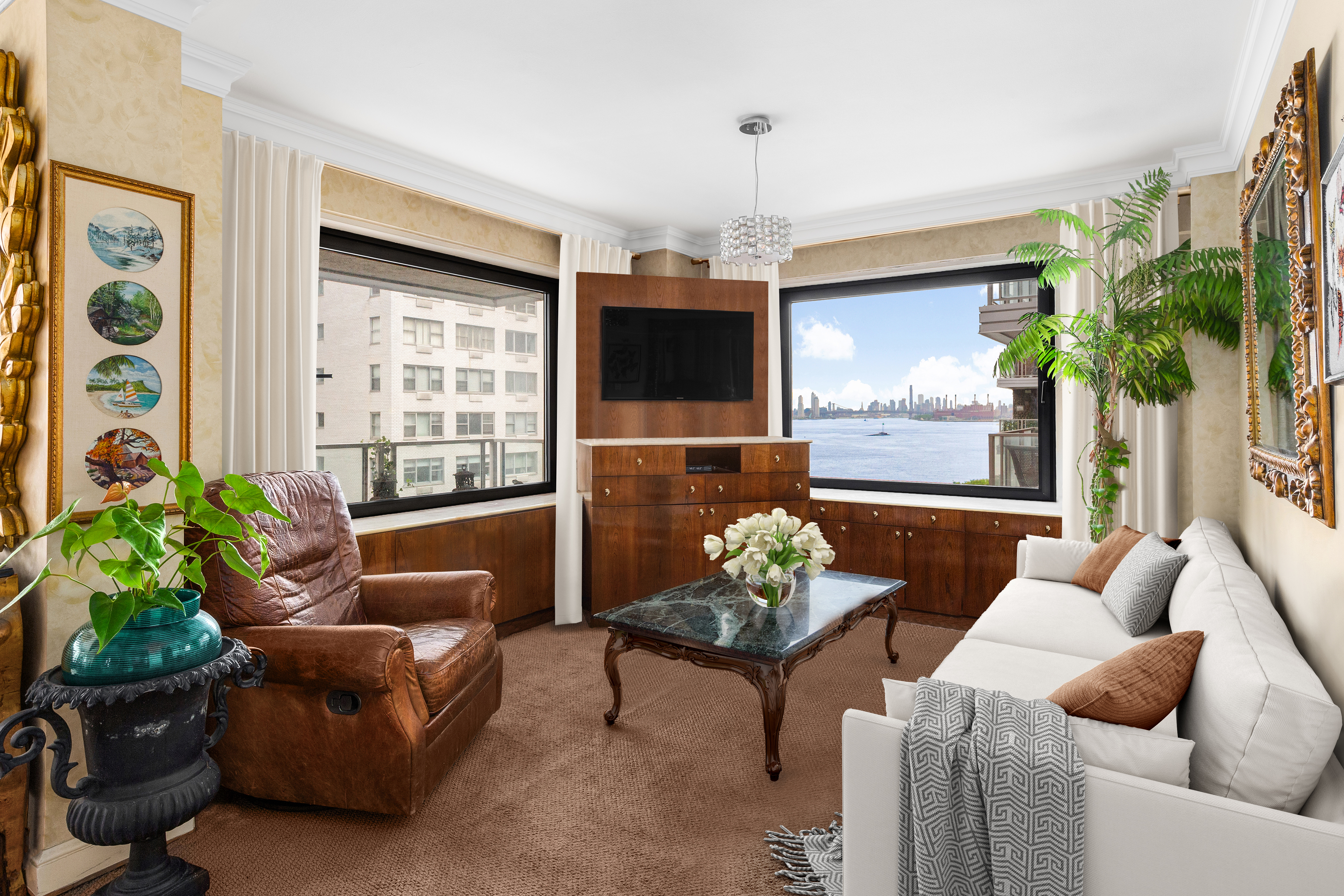50 Sutton Place South, Unit 9F Manhattan, NY 10022 - Photo 4 of 10 a living room with furniture potted plant and a window