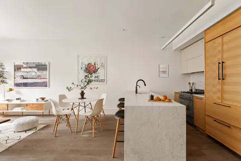 a dining room with furniture and a window