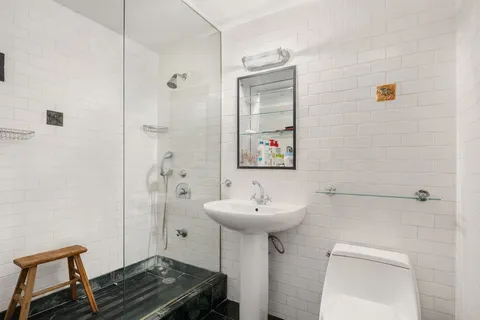a bathroom with a sink toilet and shower