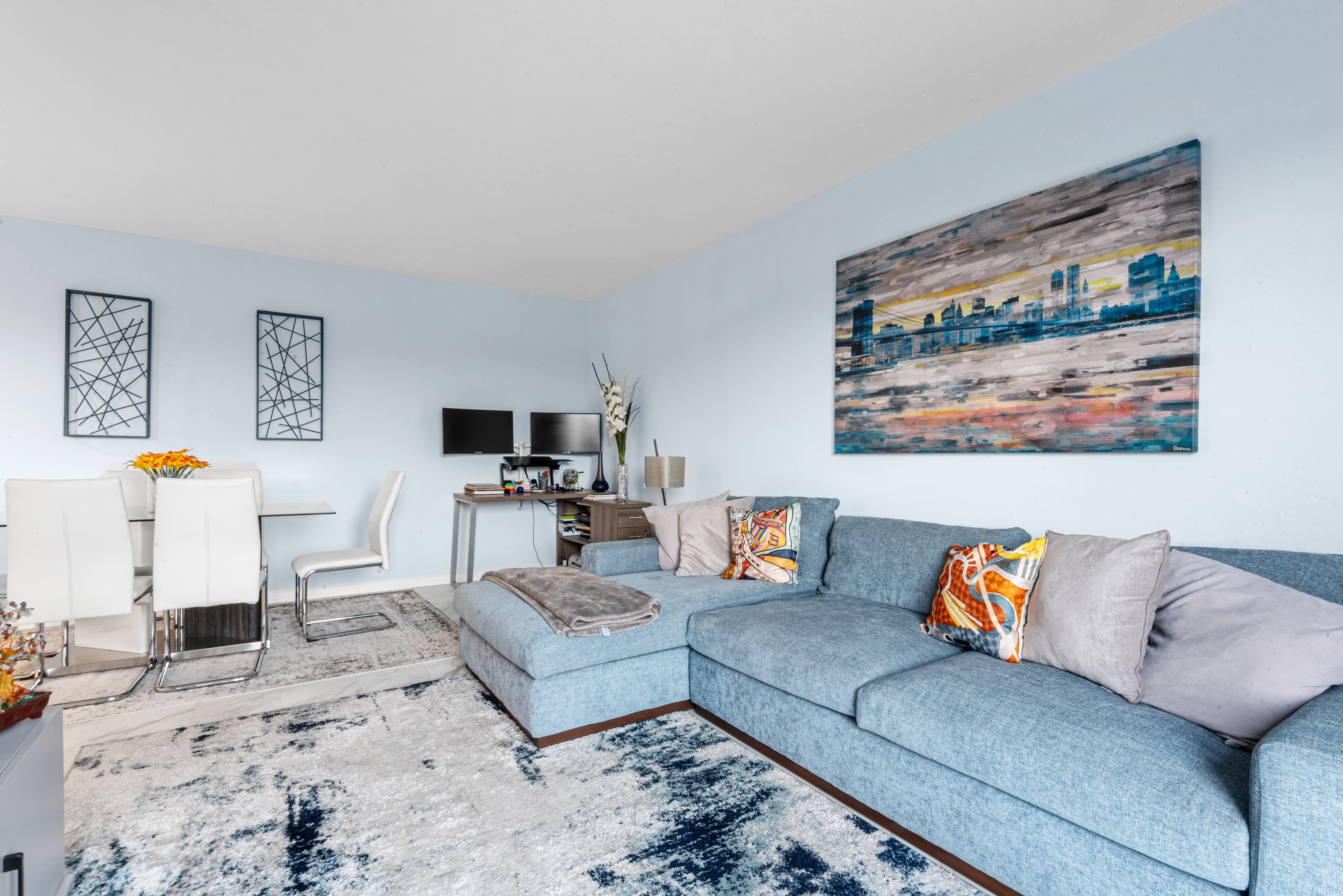 4 Horizon Road, Unit 1013 Fort Lee, NJ 07024 - Photo 7 of 18 a living room with furniture and a flat screen tv