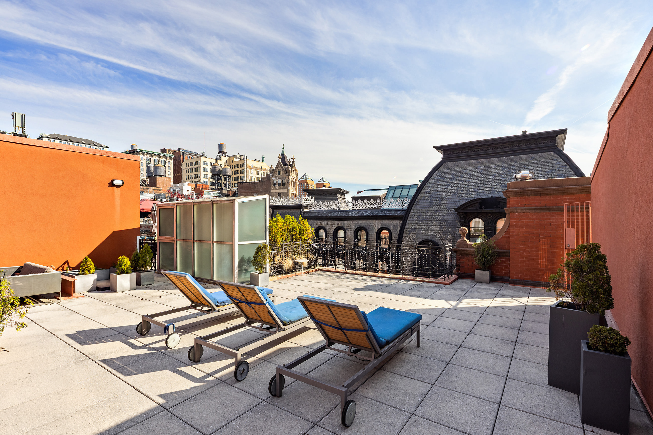 889 Broadway, Unit PHA Manhattan, NY 10003 - Photo 9 of 11 a roof deck with table and chairs a barbeque