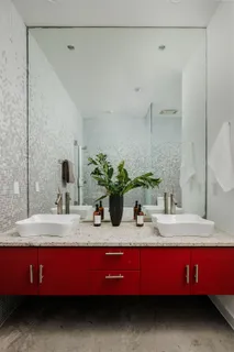 a bathroom with a granite countertop sink a mirror and shower