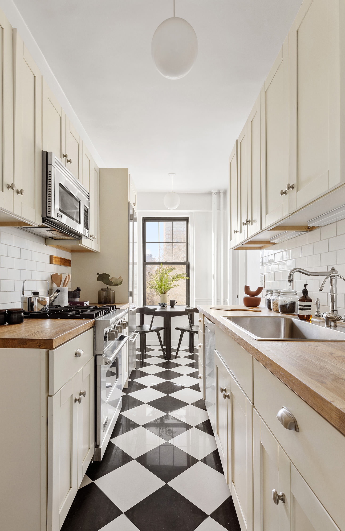 141 East 3rd Street, Unit 5H Manhattan, NY 10009 - Photo 4 of 12 a kitchen with stainless steel appliances granite countertop a sink and cabinets