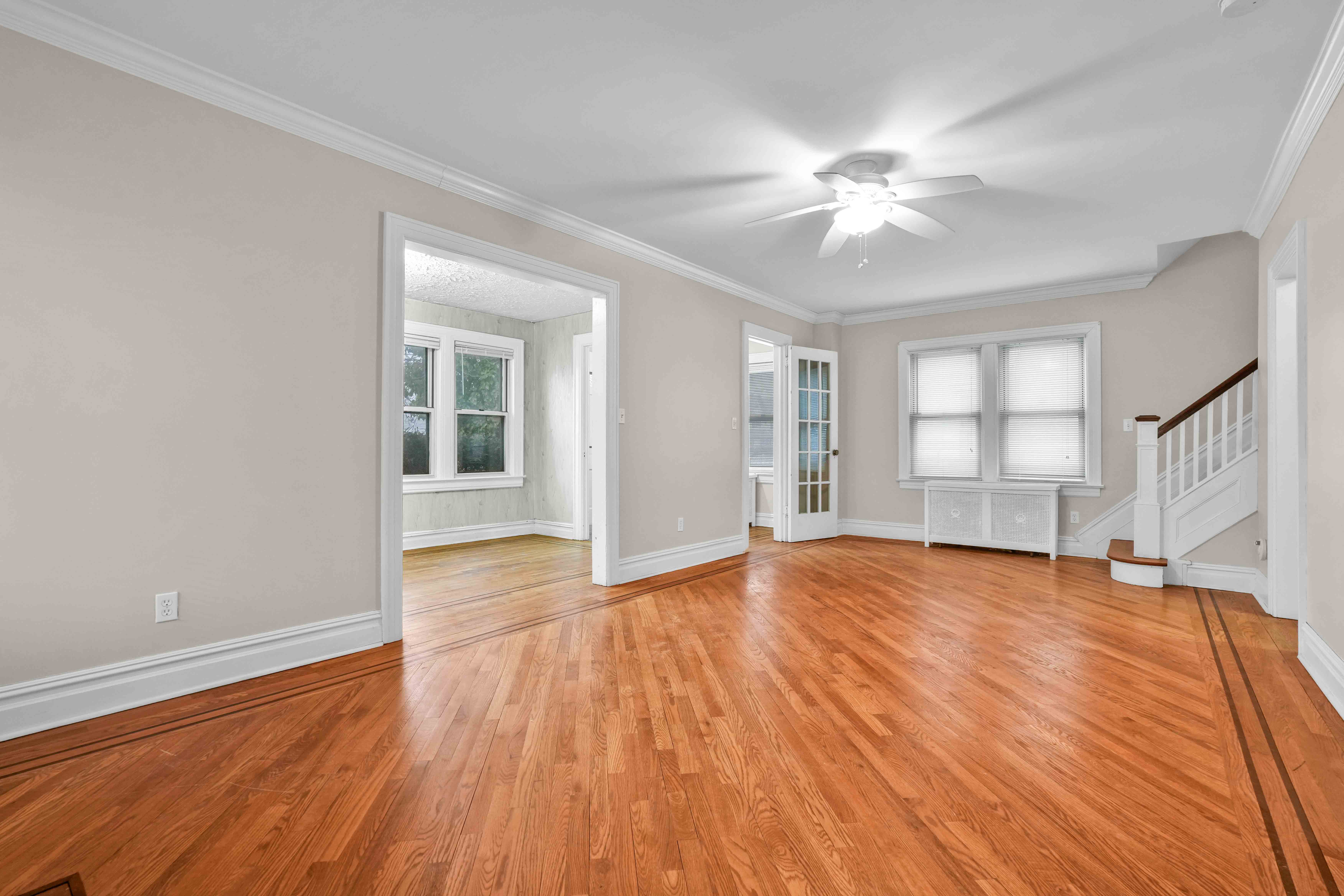 188-22 Lewiston Avenue, Unit 1 Queens, NY 11412 - Photo 5 of 17 a view of empty room with wooden floor and fan