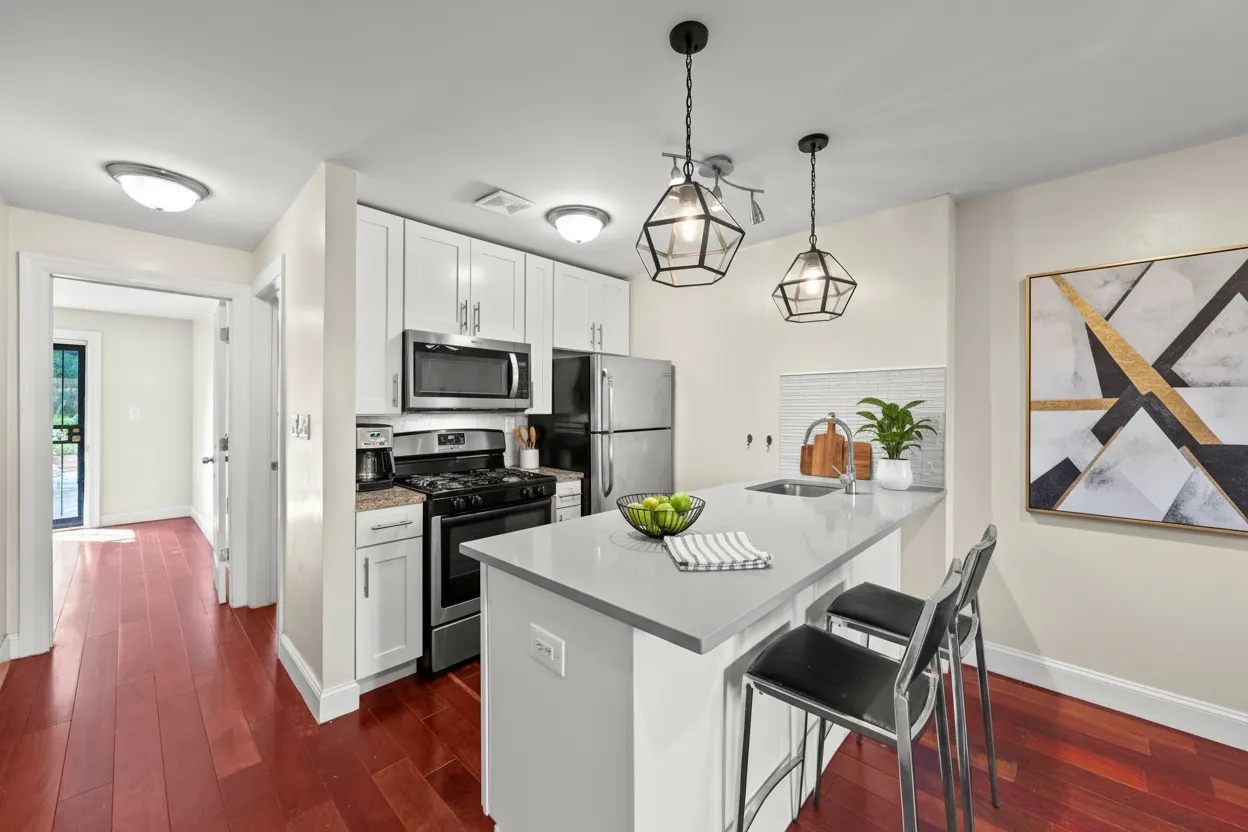 a view of a dining room and livingroom with furniture wooden floor a chandelier
