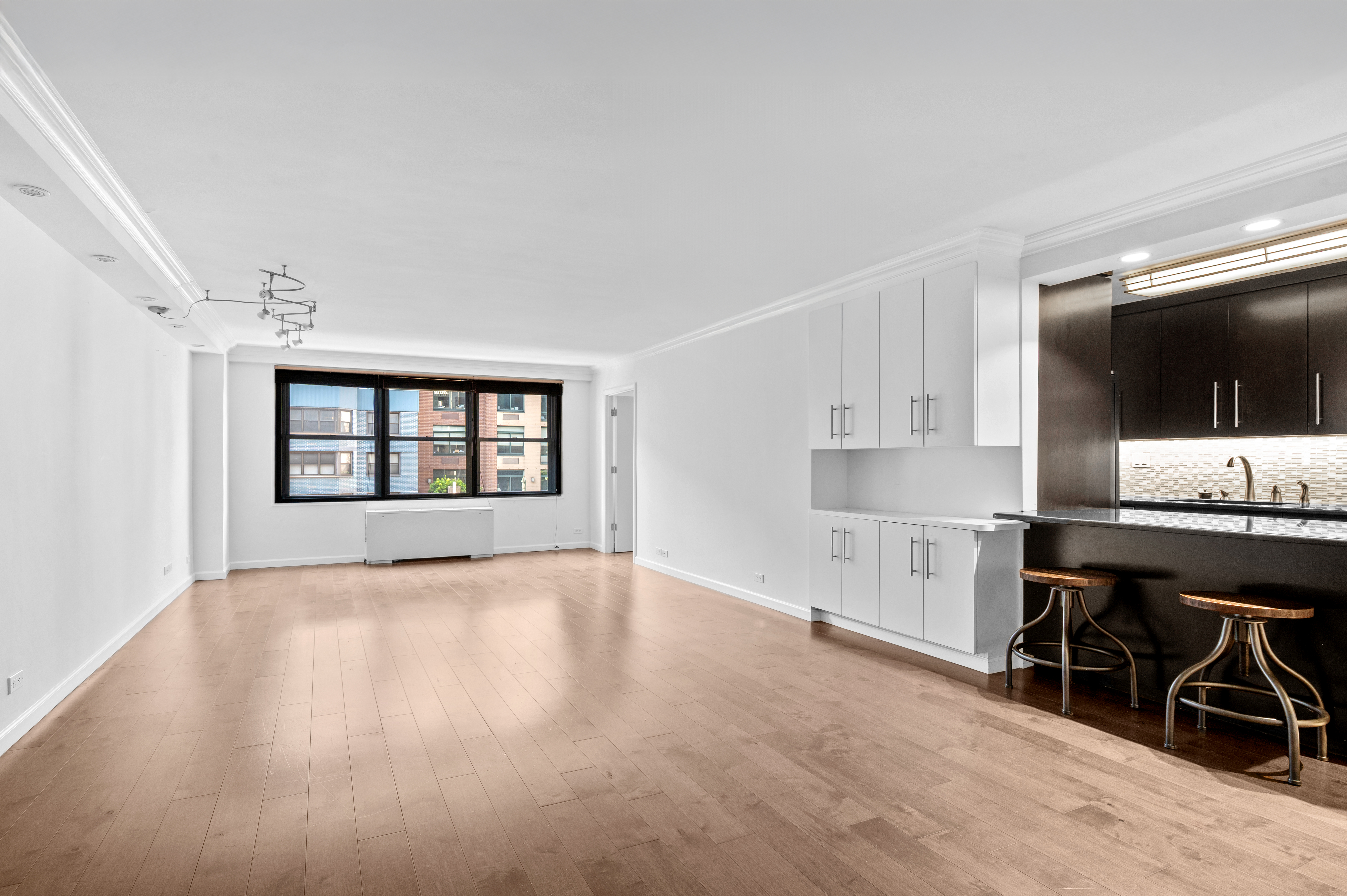 225 East 57th Street, Unit 14F Manhattan, NY 10022 - Photo 4 of 14 a view of workspace with wooden floor and windows