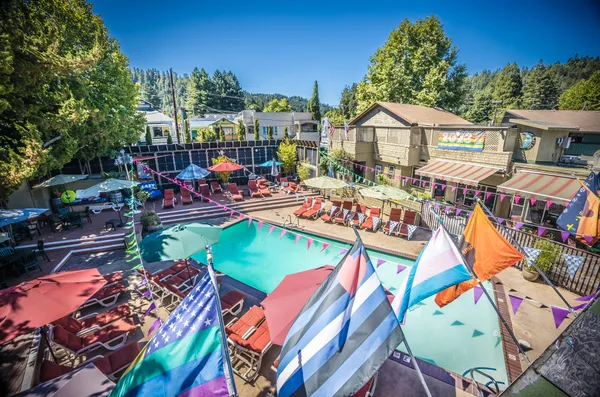 a bedroom with a bed a flat screen tv and a window