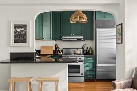a kitchen with cabinets and appliances