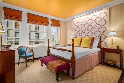 a bedroom with furniture and a lamp