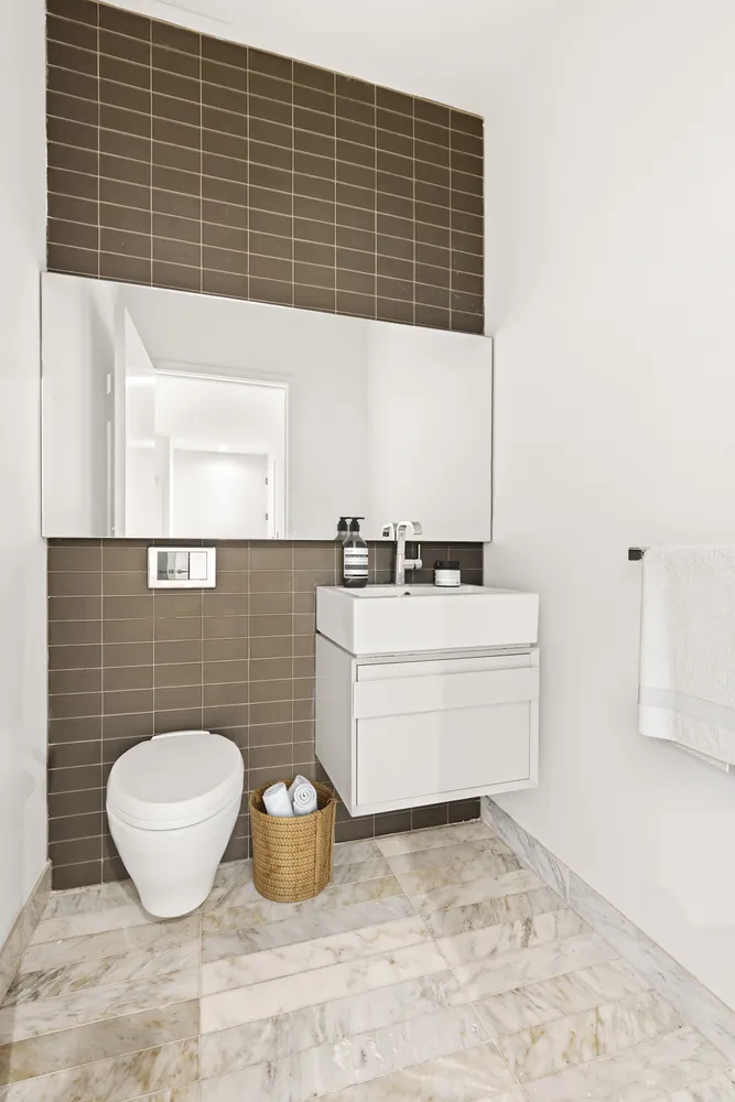 a bathroom with a sink a mirror and a toilet