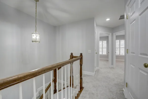 a view of a hallway with windows