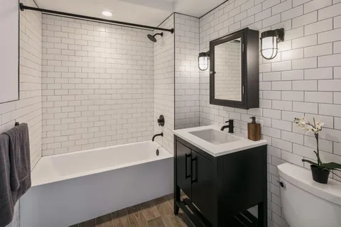 a bathroom with a sink toilet tub and shower