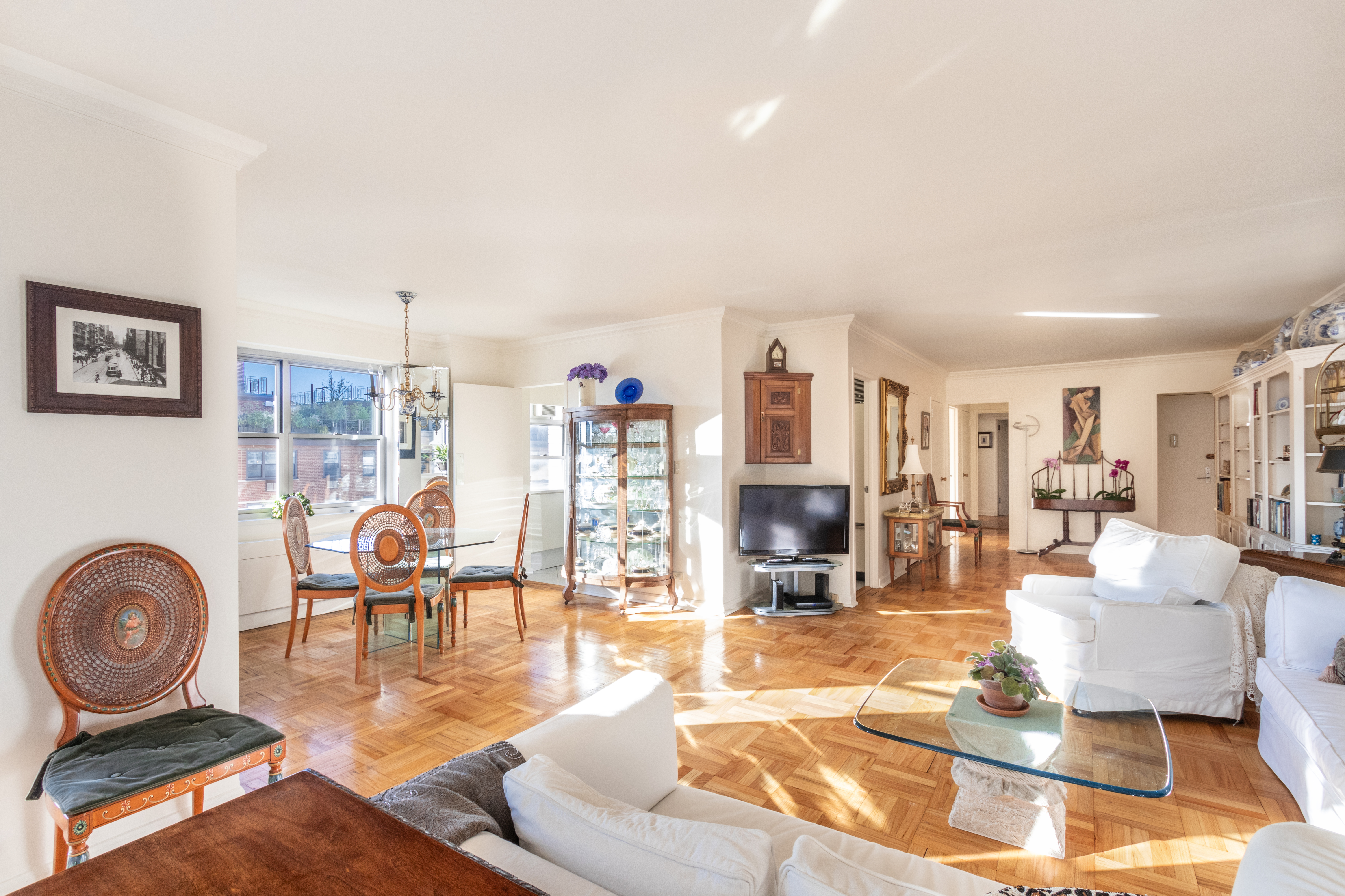 70 East 10th Street, Unit 14M Manhattan, NY 10003 - Photo 3 of 22 a living room with furniture and wooden floor