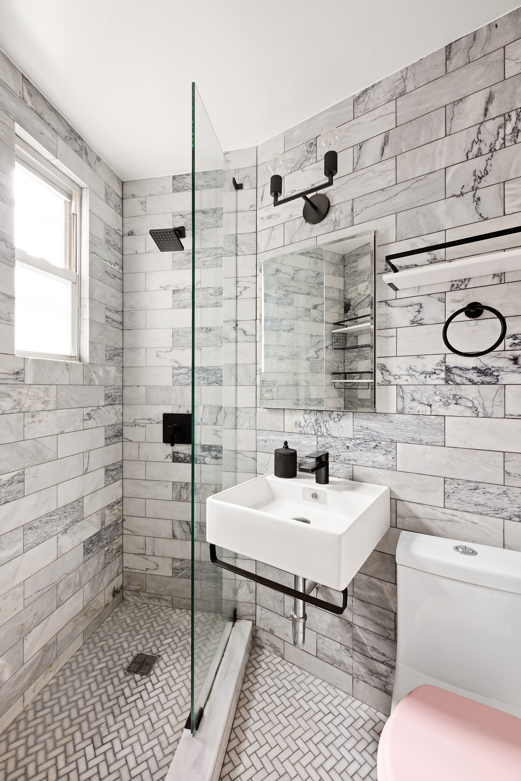 118 Perry Street, Unit J45 Manhattan, NY 10014 - Photo 4 of 6 a bathroom with a sink toilet and shower
