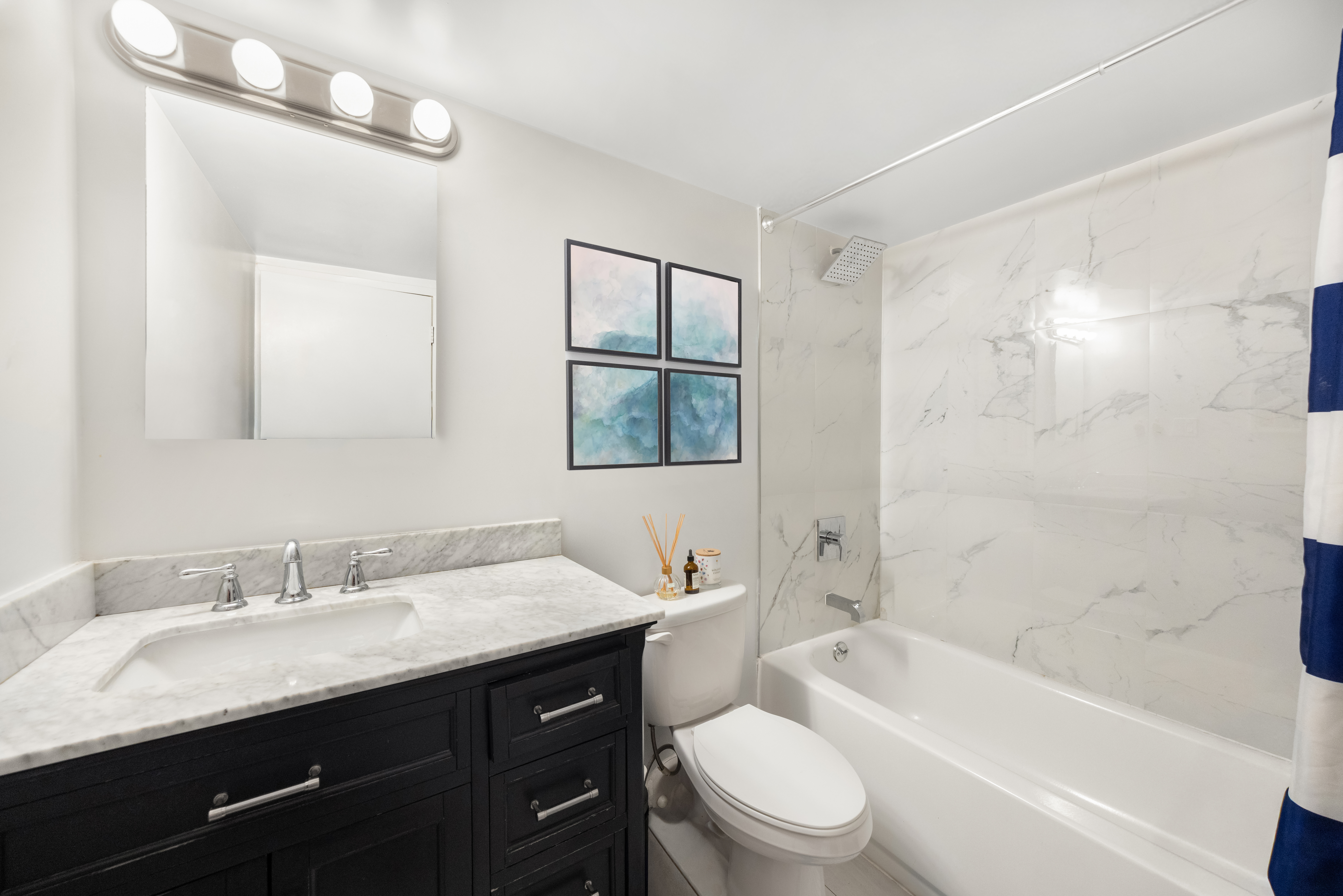 253 West 73rd Street, Unit 4N Manhattan, NY 10023 - Photo 7 of 9 a bathroom with a granite countertop sink toilet and shower
