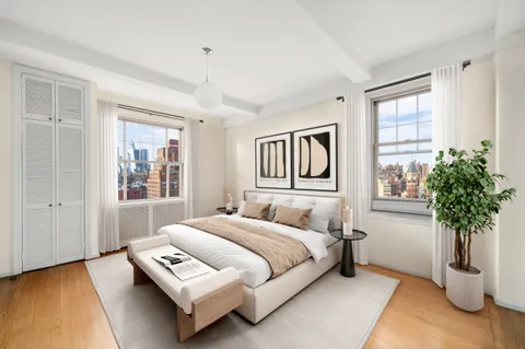 a bedroom with a bed lamp and window