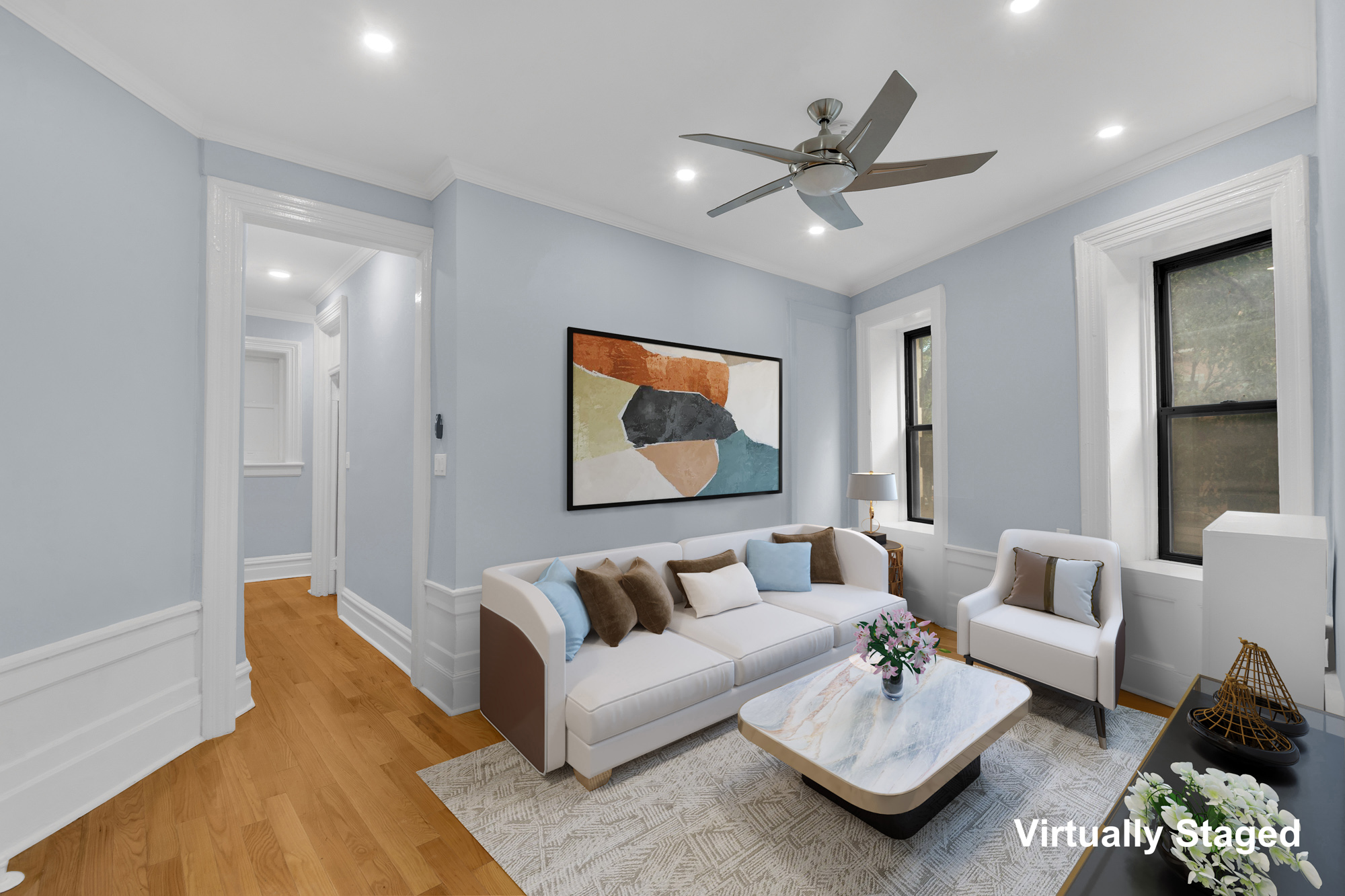 a living room with furniture and a ceiling fan