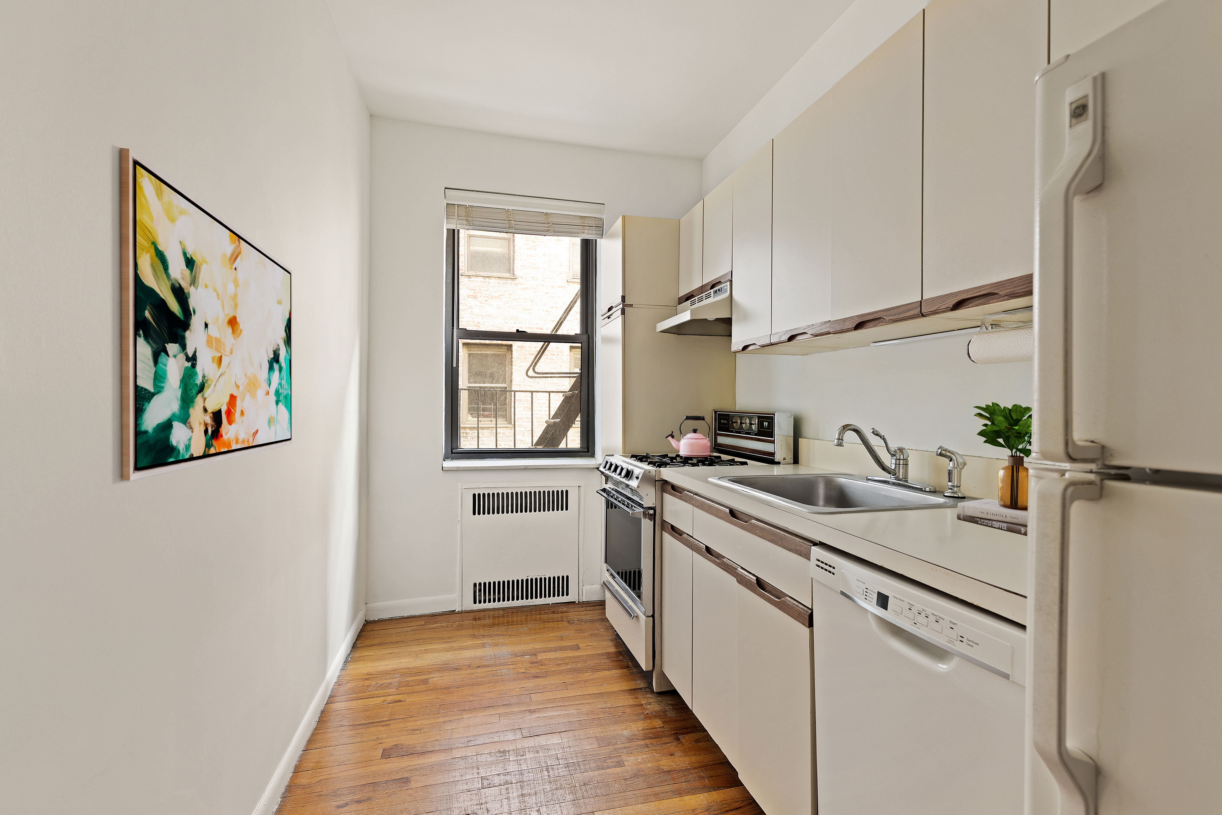 235 Lincoln Place, Unit 2D Brooklyn, NY 11217 - Photo 4 of 6 a kitchen with a sink stove and cabinets