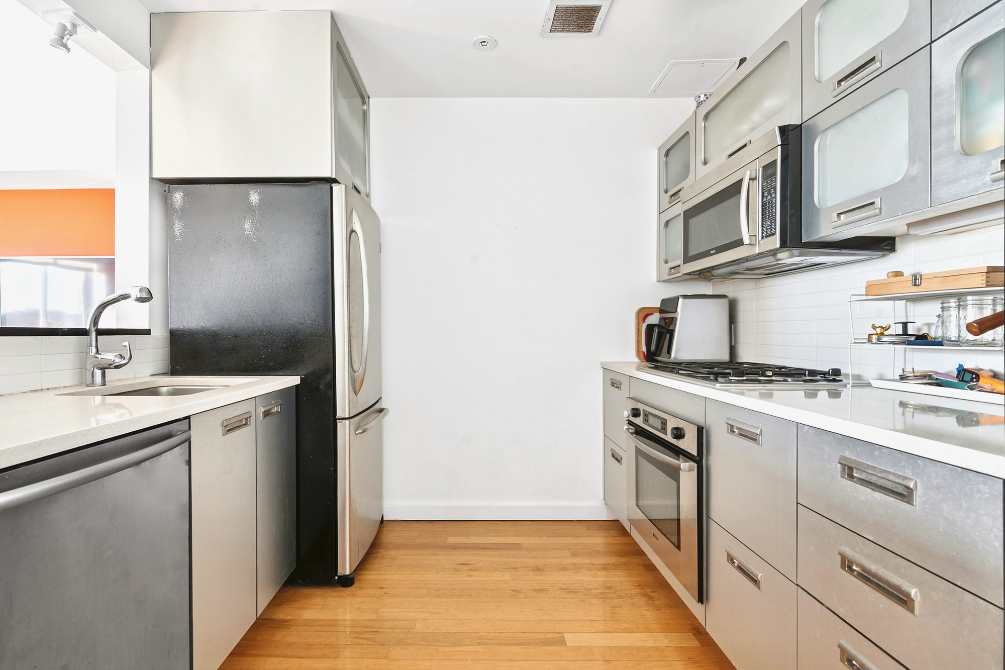 87 Smith Street, Unit 8B Brooklyn, NY 11201 - Photo 2 of 8 a kitchen with stainless steel appliances granite countertop a sink and a stove