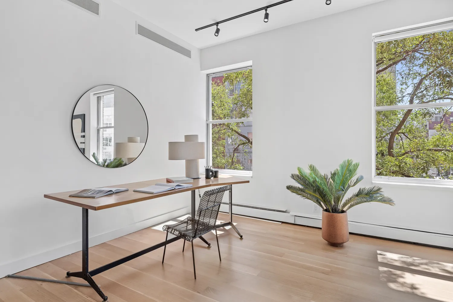 a work room with furniture and a potted plant