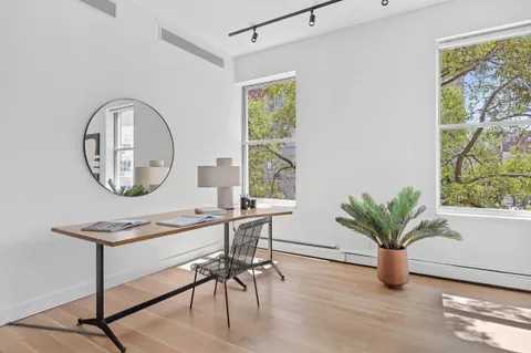 a work room with furniture and a potted plant