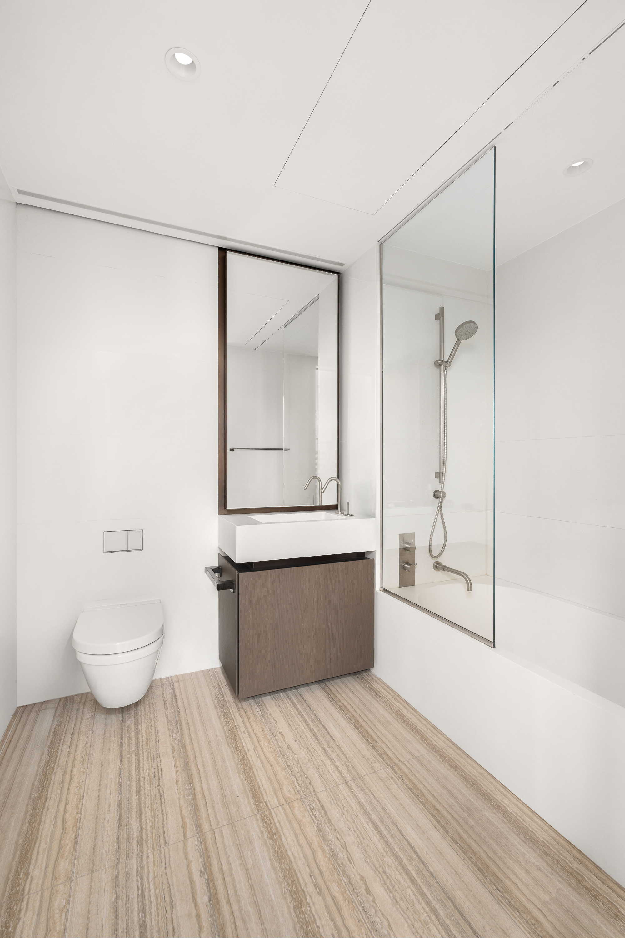 100 East 53rd Street, Unit 40A Manhattan, NY 10022 - Photo 6 of 20 a bathroom with a sink a toilet and shower