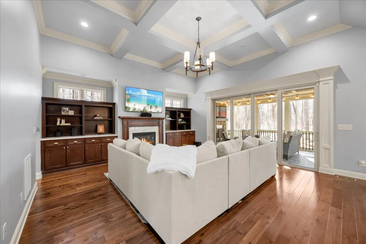 a kitchen with stainless steel appliances granite countertop a sink a stove and a wooden floors