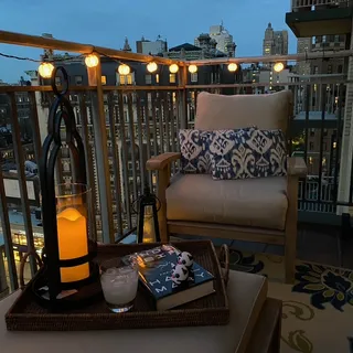 a living room with furniture and a floor to ceiling window
