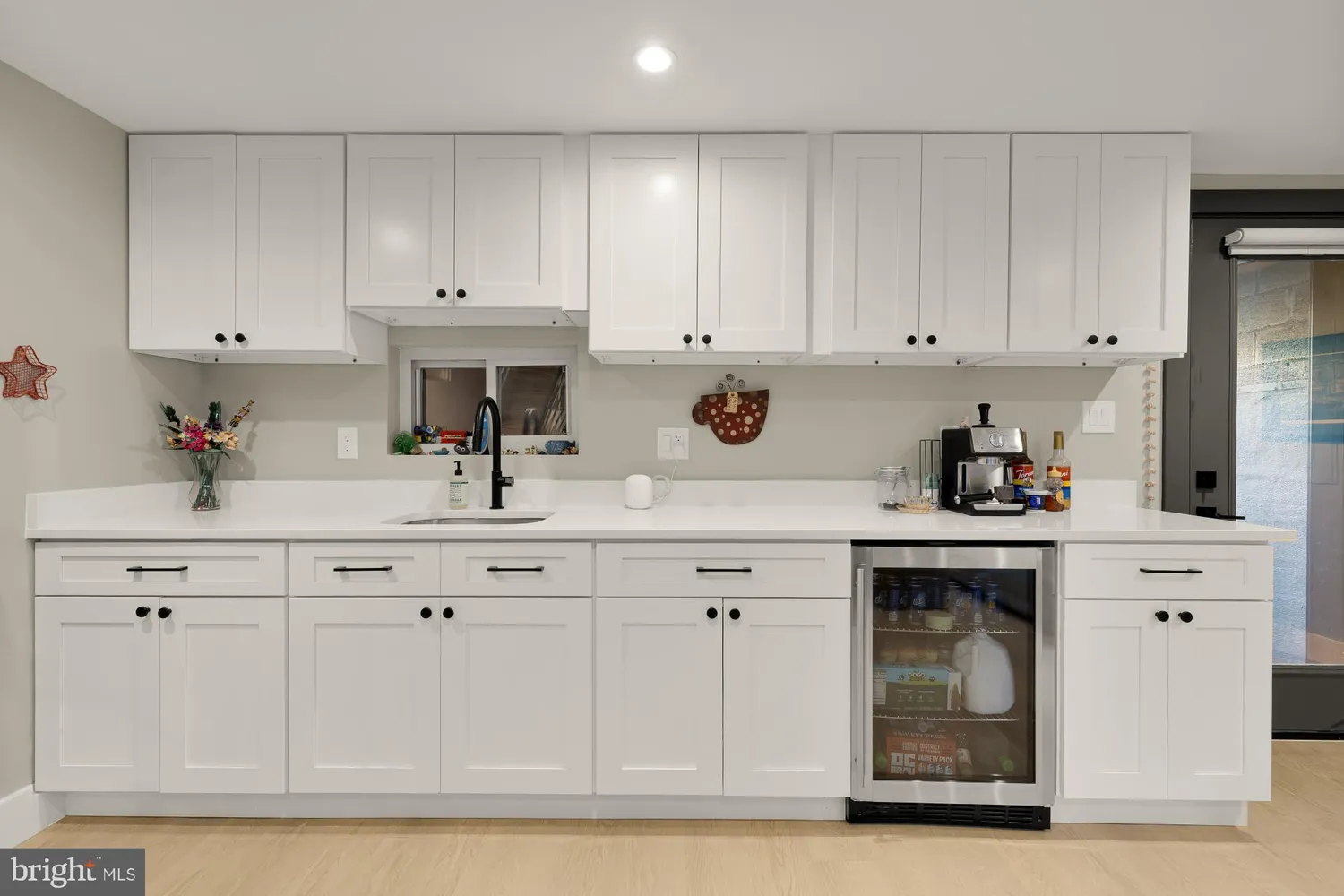 a view of kitchen with kitchen island stainless steel appliances refrigerator stove microwave and cabinets