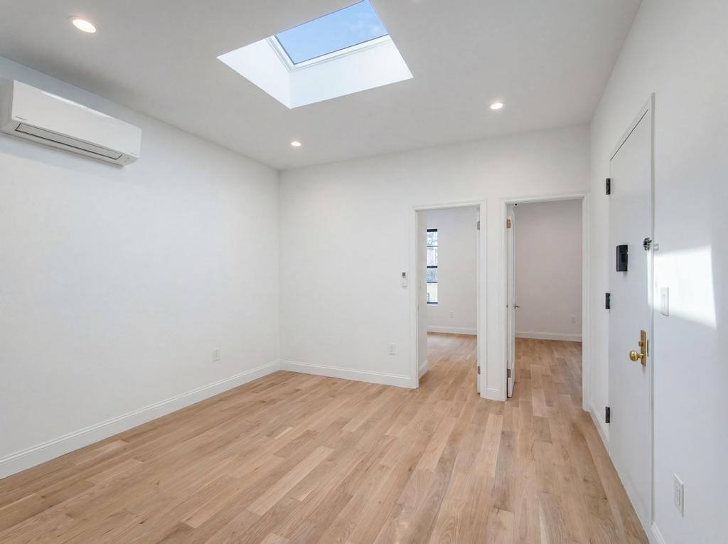 231 East 60th Street, Unit 5 Manhattan, NY 10022 - Photo 4 of 11 a view of an empty room with wooden floor