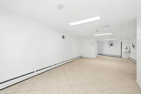 an empty room with white walls and tiles