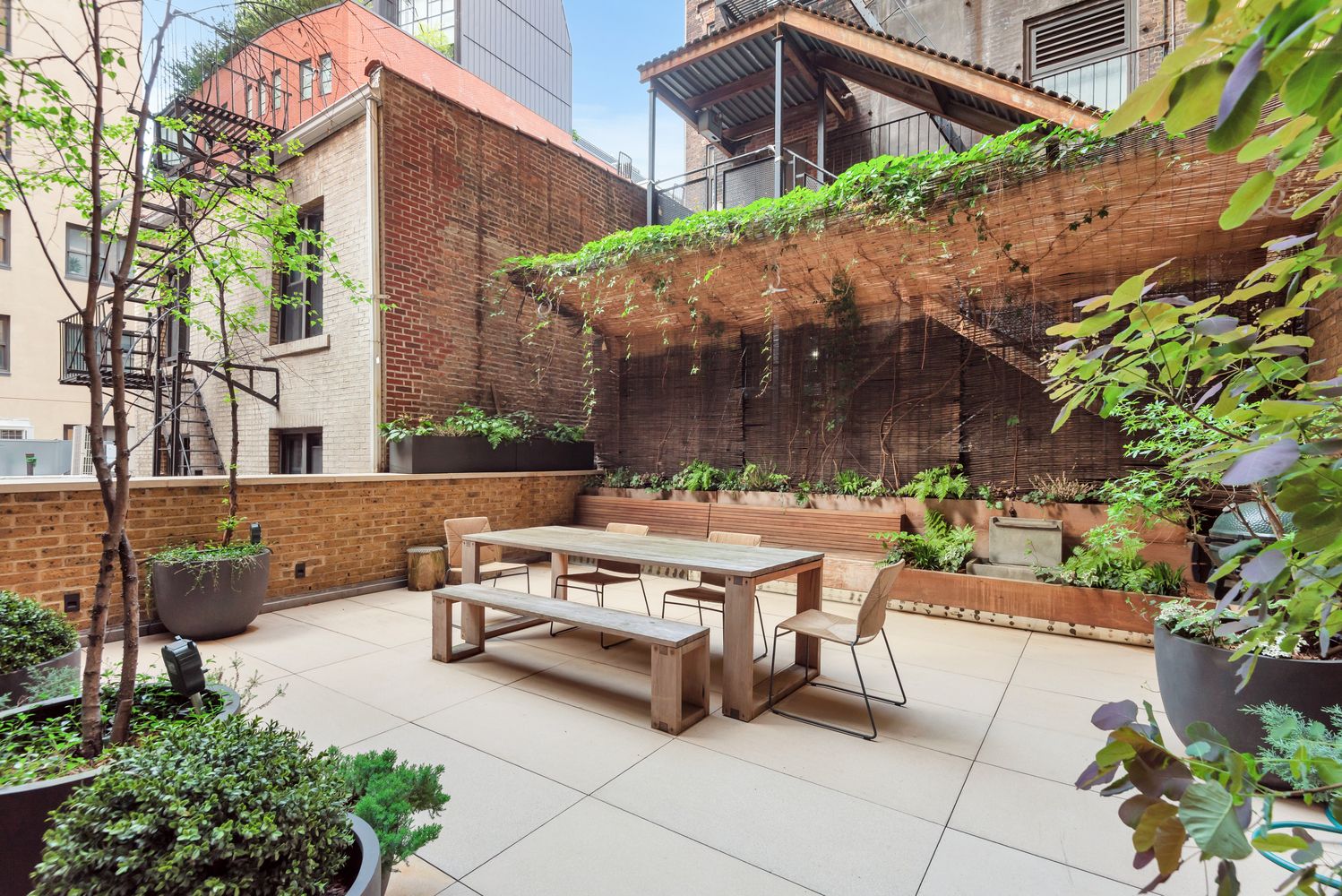 a view of a patio with table and chairs under an umbrella